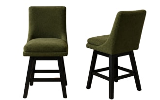 Two green upholstered swivel bar stools with cushioned seats and black wooden legs, ideal for kitchen or home bar seating.
