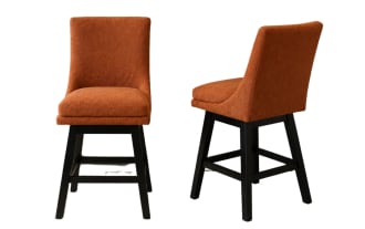 Set of two modern dining chairs with burnt orange upholstered fabric seats and backs, featuring black wooden legs and crossbars for support.