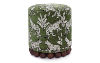 Green cylindrical fabric ottoman with white leopard and leaf patterns, featuring a wooden bead base for stylish living room seating or decor.