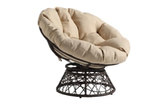 Round papasan chair with a black woven metal base and a thick, tufted beige cushion, designed for comfortable seating.