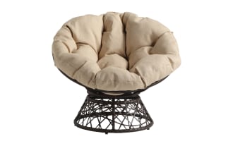 Round papasan chair with a black woven metal base and a thick, tufted beige cushion, designed for comfortable seating.