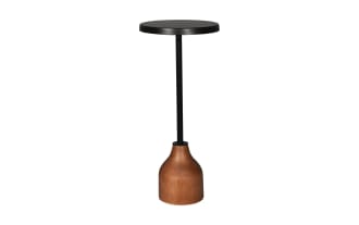 Modern side table with a round black metal top, slender black metal stem, and a curved wooden base in natural brown finish, suitable for living rooms.