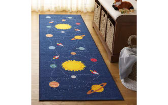 Orbit Adventure 2' x 6' blue runner rug with playful space design, navy background, yellow suns, red rockets, and synthetic polyamide fabric.