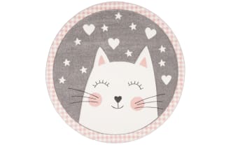 Round children's rug featuring a smiling white cat face with pink cheeks, surrounded by white hearts and stars on a gray background, and a pink gingham border.