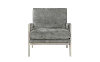 Gray upholstered armchair with plush cushions, whitewashed wooden frame, and mid-century modern design, ideal for living room seating.