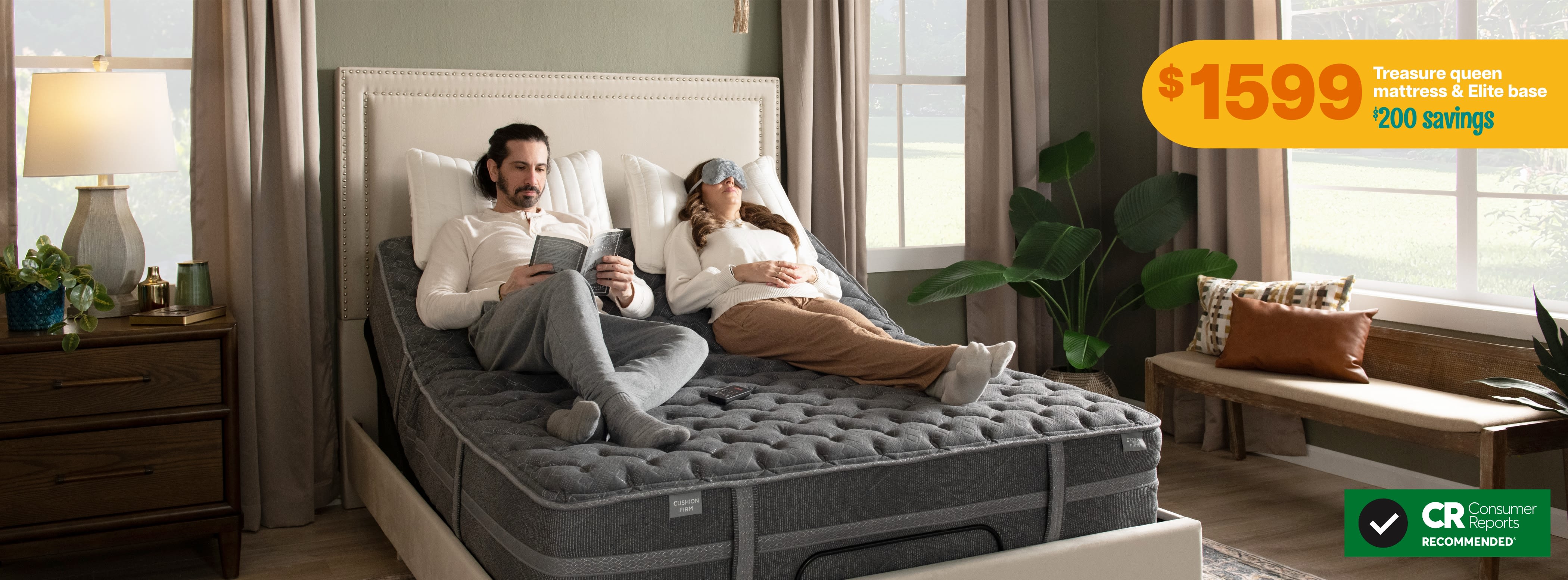 Couple lounging on a dual feel Treasure mattress with an Elite adjustable base