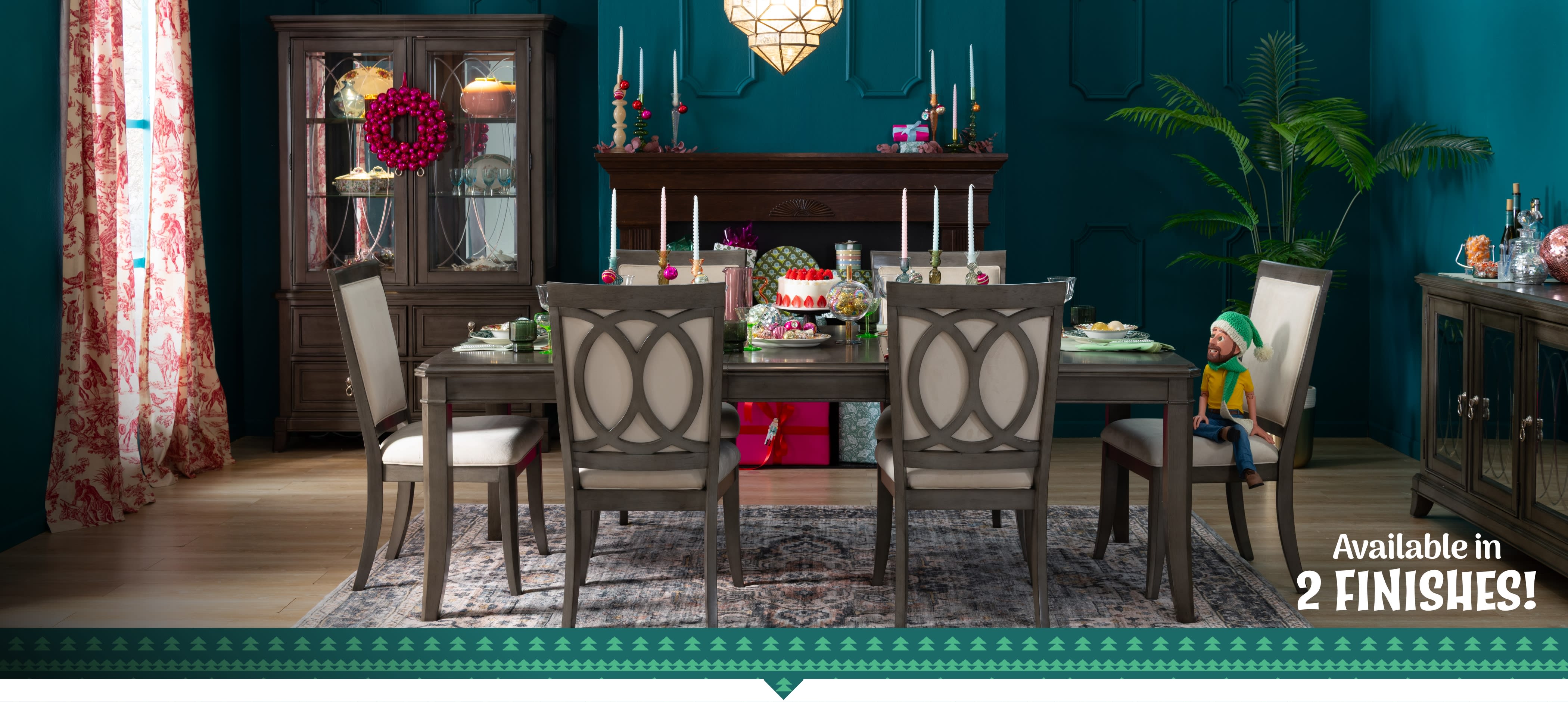 A stylish dining table set with six chairs, decorated for a festive occasion with a cake and colorful ornaments.