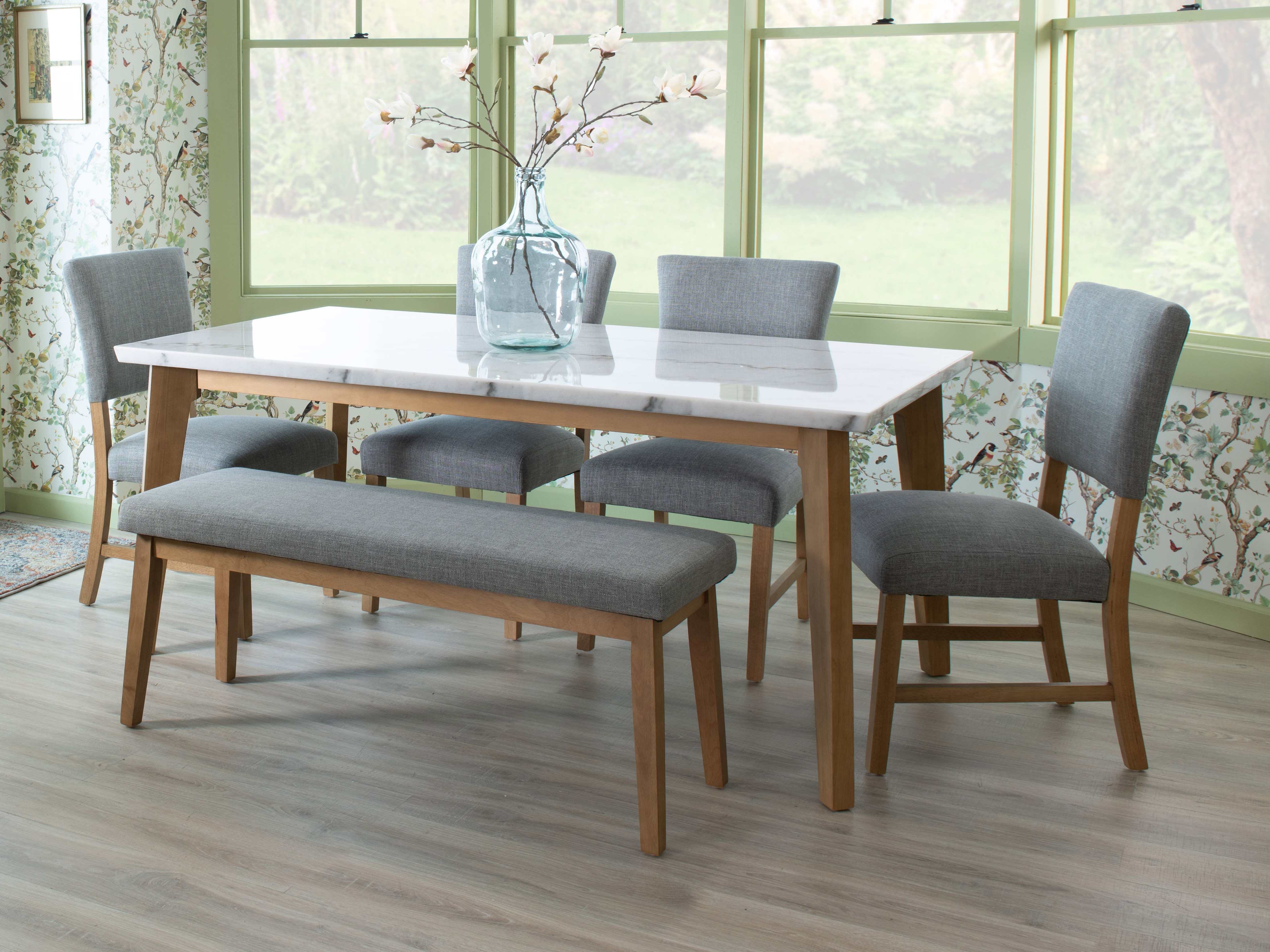 White marble dining table with 4 gray chairs and bench