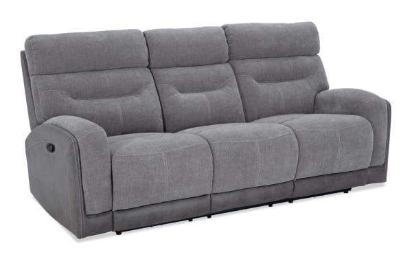 Phantom Gray 86'' manual reclining sofa in gray polyester fabric with plush cushioning, transitional style, and memory foam seating.