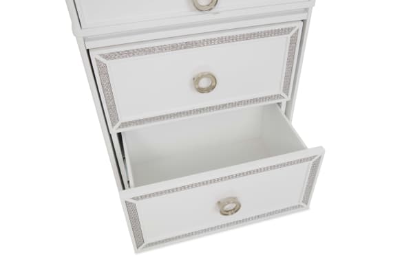 White wooden dresser drawers with silver ring handles and decorative silver trim, one drawer partially open showing spacious interior.