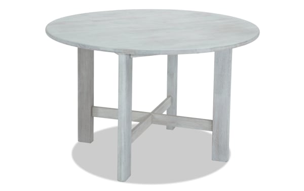 Mango White solid wood round dining table in contemporary style with cross-braced legs, part of Mango Dining collection.