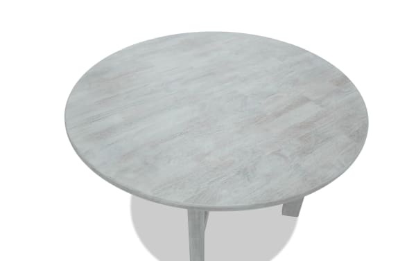 Mango White solid wood round dining table in contemporary style with smooth light finish, part of Mango Dining collection, ideal for family meals.