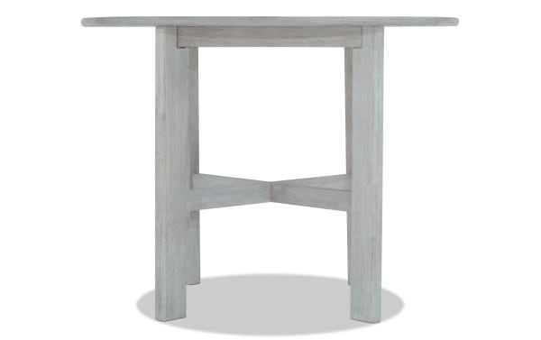 Mango White solid wood round dining table in contemporary style with counter-height and cross-braced legs from Mango Dining collection.