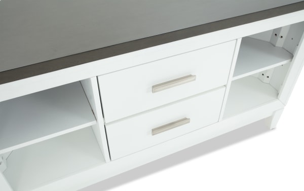White wooden sideboard with two silver metal handles on drawers, open shelving on sides, and a dark gray tabletop surface.