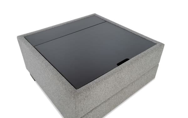 Gray Playday transitional upholstered lift-top square tray table ottoman with polyester fabric, MDF top, hidden storage, and wheels for mobility.