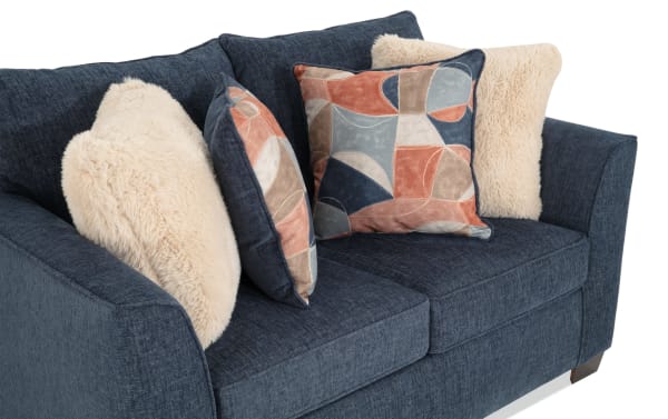 Brynn Navy 64'' Loveseat in transitional style with soft navy polyester fabric, memory foam cushions, and decorative beige and patterned accent pillows.