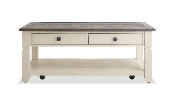 Laurel White & Brown Storage Coffee Table with two-tone MDF, rubberwood, and acacia veneers, cottage style, distressed top, black hardware, casters, drawers, and lower shelf for storage.