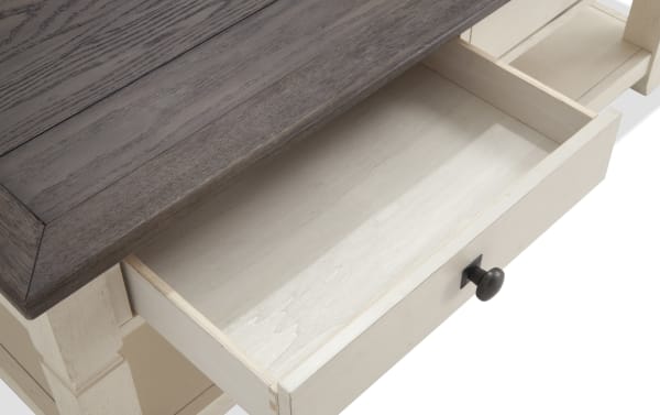 Open drawer of Laurel White & Brown Storage Coffee Table showing light wood interior, black knob, and two-tone cottage style with MDF, rubberwood, and acacia veneers.