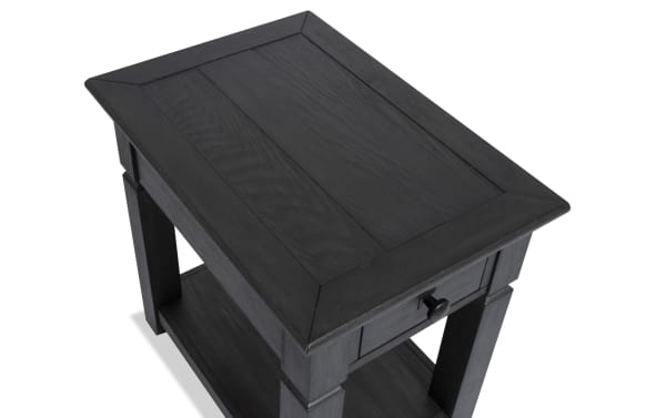 Rustic Laurel Charcoal Storage Chairside Table with distressed charcoal finish, single drawer, and lower shelf for storage, made of MDF, rubberwood, and acacia veneers.