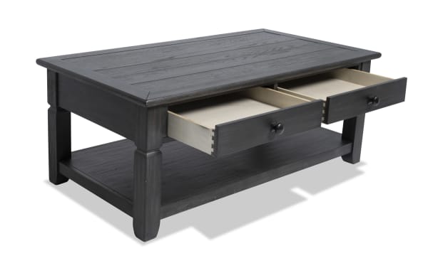 Rustic Laurel Charcoal Storage Coffee Table from Laurel Entertainment & Occasional collection, featuring charcoal MDF, rubberwood, acacia veneers, two drawers, and a lower shelf for organized storage.
