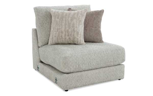 Posh Beige Armless Chair in transitional style with plush beige polyester fabric, gel-infused memory foam, and two accent pillows from the Posh collection.