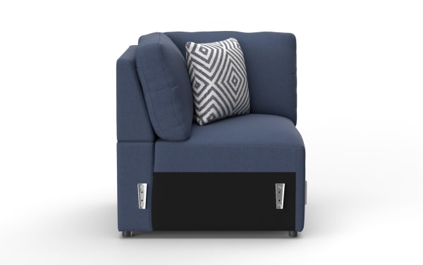 Blue fabric sectional sofa corner piece with plush cushions and a decorative geometric black and white throw pillow, modern design.