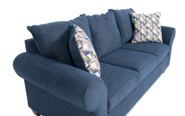 Kylie Navy 92'' transitional sofa with plush polyester fabric upholstery, roll arms, memory foam cushions, and patterned accent pillows.