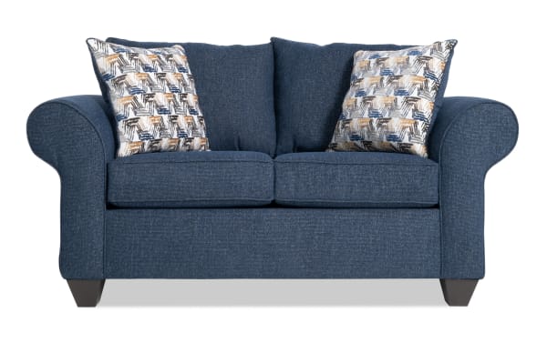 Kylie Navy 70'' transitional loveseat upholstered in navy blue polyester fabric with rolled arms, memory foam cushions, no-sag springs, and patterned accent pillows.