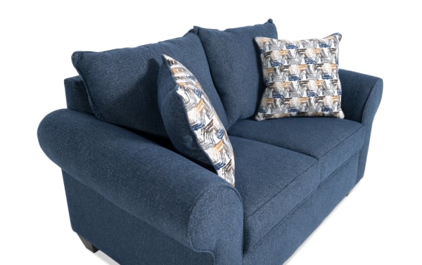 Kylie Navy 70'' loveseat with plush polyester fabric upholstery, roll arms, and patterned accent pillows in blue transitional style.