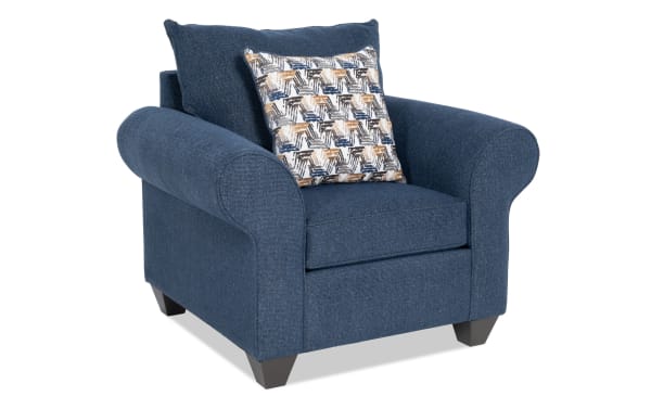 Kylie Navy Chair in blue polyester fabric with rolled arms, plush memory foam cushioning, no-sag springs, and a patterned accent pillow.