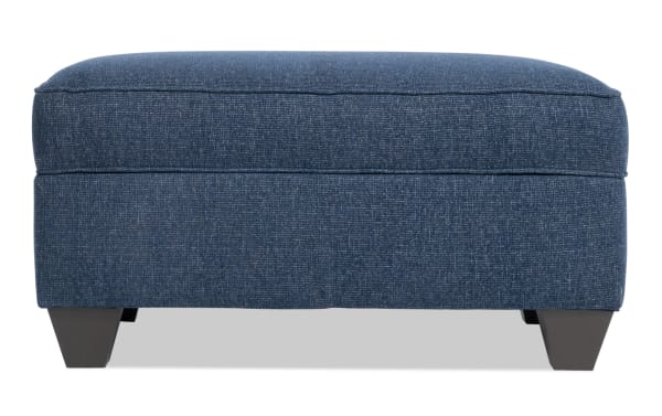 Transitional Kylie Navy Storage Ottoman with layered cushion foam, no-sag sinuous spring seating, hidden storage, and durable polyester fabric upholstery.