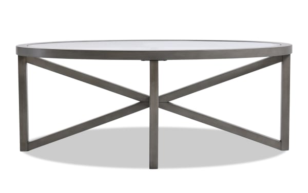 Zoey Gray oval glass top coffee table with beveled glass surface, gray MDF frame, and X-shaped transitional style legs.