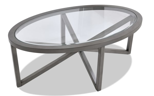 Zoey Gray transitional oval coffee table with beveled glass top and gray MDF frame, featuring a modern crossed leg design.