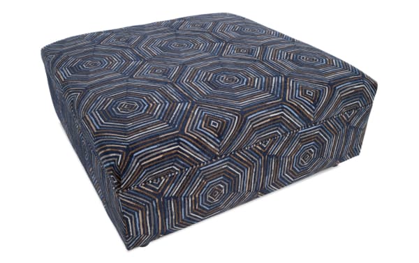 Juno Multicolored Ottoman with transitional style, cozy patterned polyester fabric, and cushioned foam layer for comfortable footrest or seating.