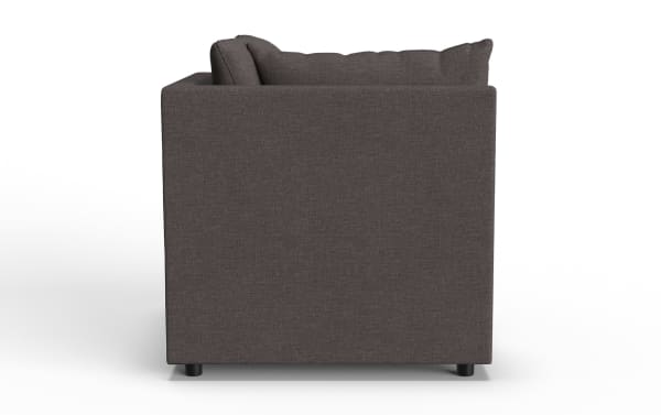 Dark gray fabric armchair with a modern, boxy design and cushioned backrest, featuring short black legs for support.