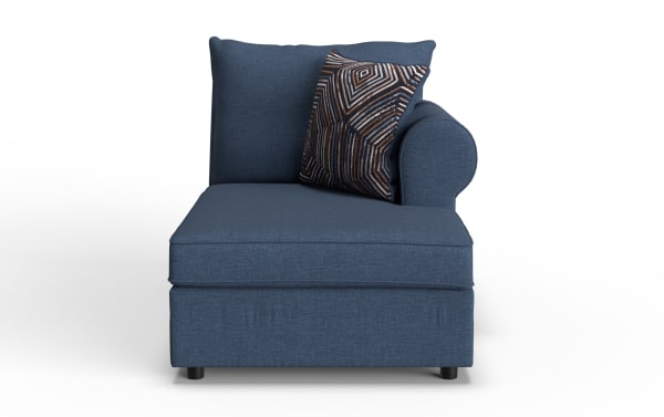 Blue fabric chaise lounge with a cushioned backrest, rounded armrest on the right, and a decorative geometric patterned throw pillow.