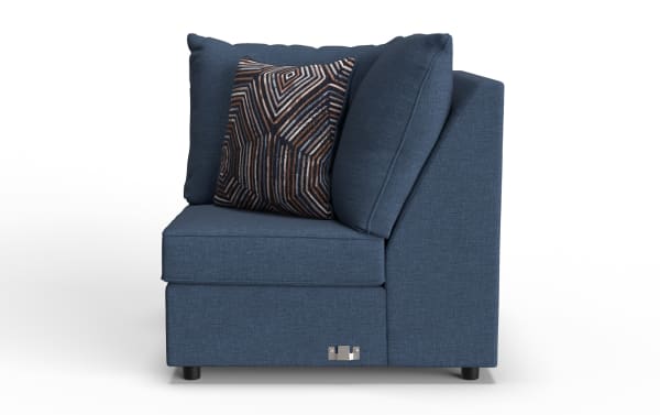 Modern navy blue fabric corner sofa section with geometric patterned accent pillow, plush cushions, and black legs, ideal for living room seating.
