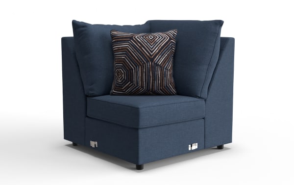 Modern navy blue fabric corner chair with plush cushions and a decorative geometric patterned throw pillow, ideal for living room seating.