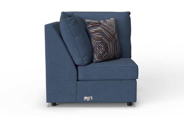Blue fabric corner sofa section with a geometric patterned accent pillow, featuring a modern design and metal connector hardware at the base.