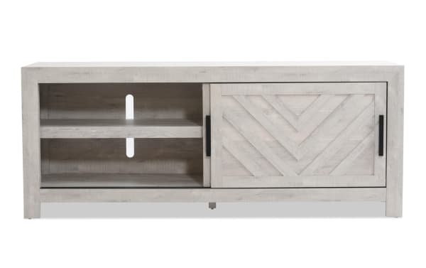 Calvin 65'' white MDF TV stand from Calvin Entertainment & Occasional collection, transitional style with chevron plank design, sliding door, adjustable shelves, and cord management.
