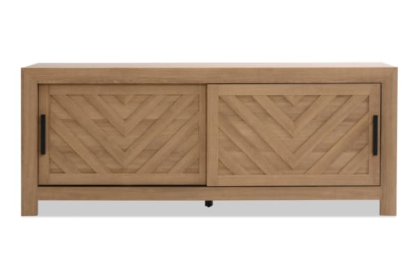 Calvin 65'' light brown MDF TV stand from Calvin Entertainment & Occasional collection, featuring transitional style, chevron plank design, sliding doors, and natural wood grain texture.