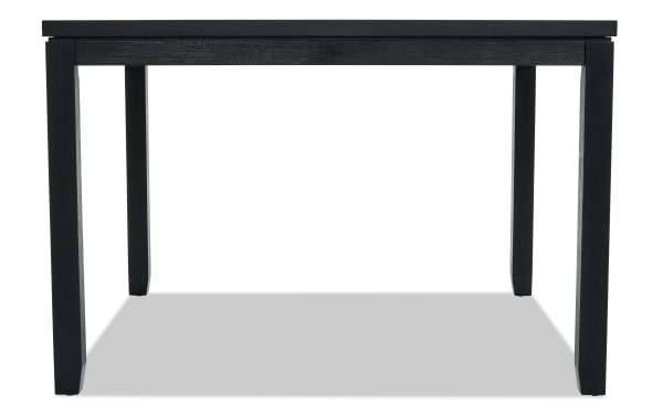 Black wooden dining table with a simple rectangular design, four sturdy legs, and a smooth flat top, suitable for modern interiors.