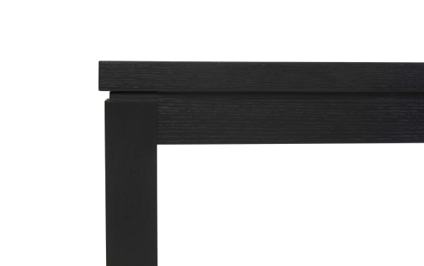 Close-up of a black wooden table corner showing the smooth finish and grain texture, highlighting durable modern furniture design.