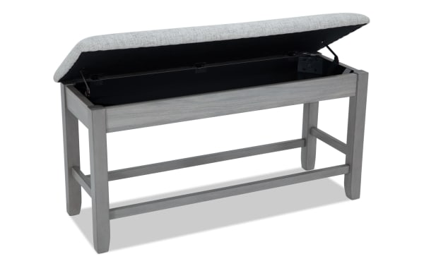 Homeworks Gray Upholstered Counter Height Storage Dining Bench with soft polyester cushion, gray melamine wood frame, and lift-top storage.
