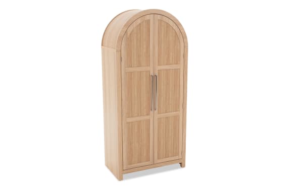 Tall wooden wardrobe with arched top, double doors, vertical grooves, and metal handles, suitable for bedroom storage.