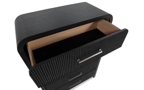 Cascade Black 5 Drawer Chest in transitional style with black engineered wood grain, smooth rounded edges, and reeded drawer fronts, featuring a felt-lined top drawer for organized storage.