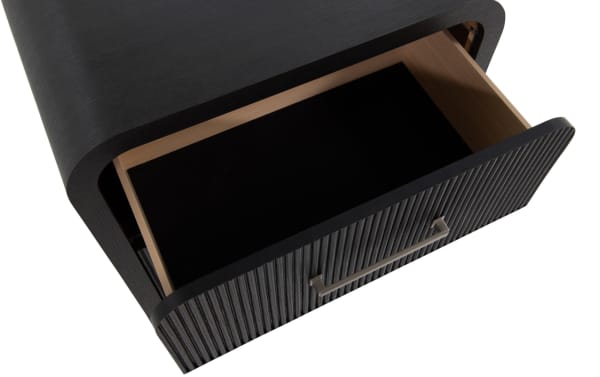 Cascade Black 2 Drawer Nightstand from Cascade Bedroom collection, featuring transitional style, black engineered wood grain, reeded drawer fronts, rounded corners, and metal handle.