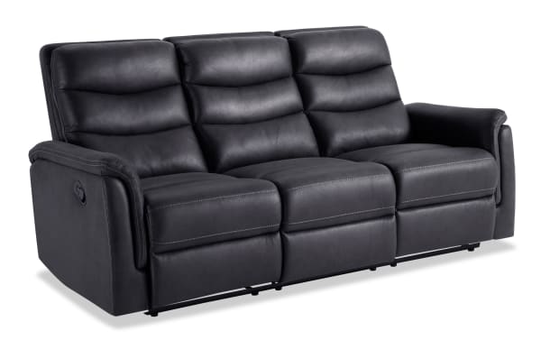 Forte Charcoal 82'' manual reclining sofa in gray polyester fabric with padded arms, Bob-O-Pedic memory foam cushions, and contrasting stitch detailing.