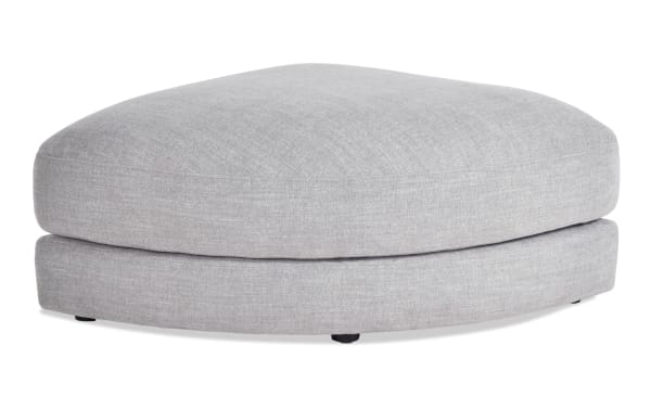 Gray Gravity Curved Ottoman with soft polyester fabric upholstery, plush feather-blend topper, and contemporary rounded design for modular sectional comfort.