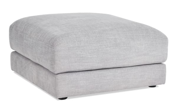 Gravity Gray Square Ottoman in contemporary style, featuring soft gray polyester fabric upholstery with a plush Bob-O-Pedic® feather blend topper, part of the Gravity collection.